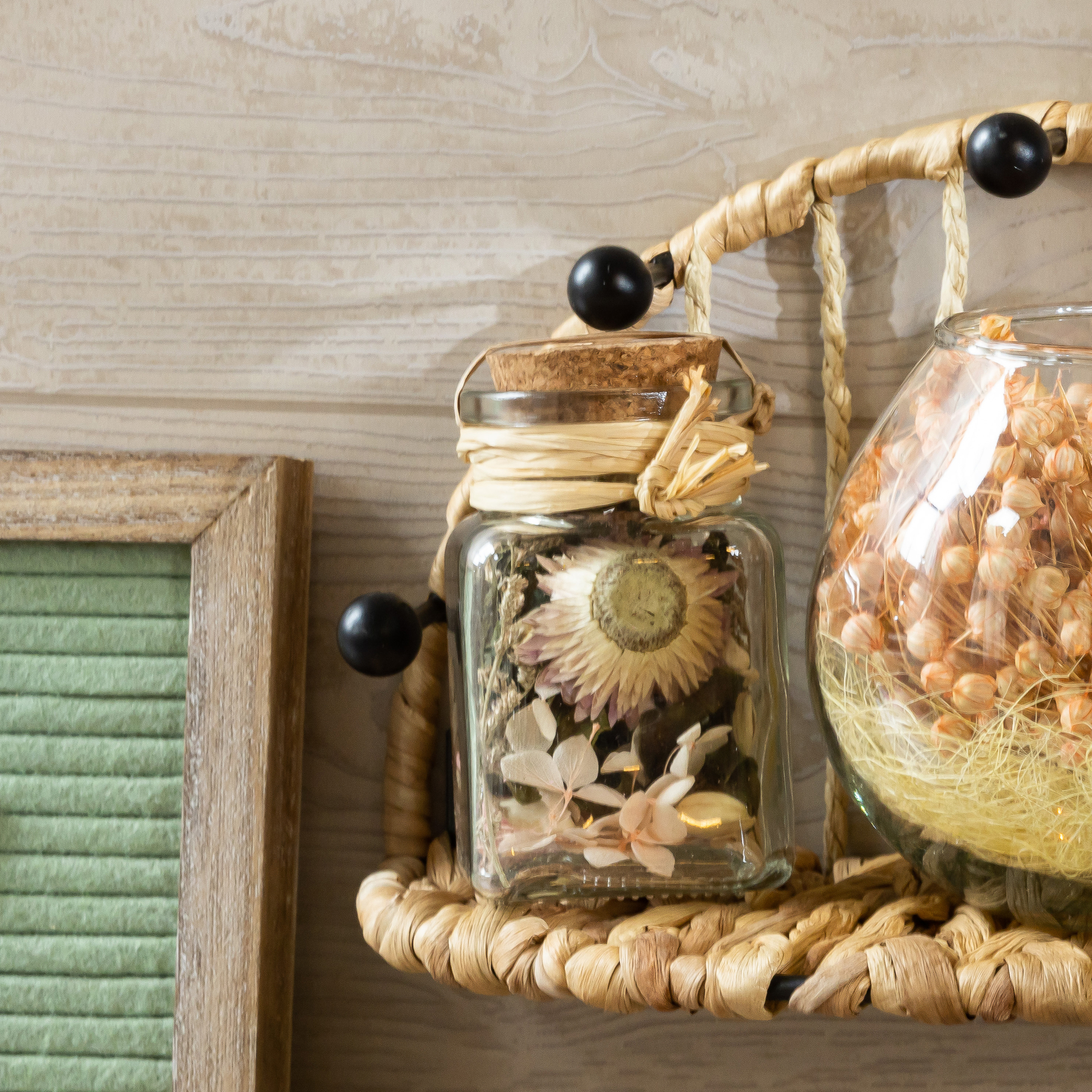 cork topped glass bottle with faux plants